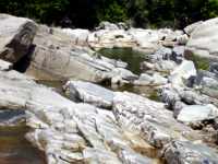 Exposed rock and river-tumbled boulders along and around the river