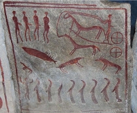 Petroglyph with four humans top left, a chariot drawn by two horses with a charioteer top right, four animals in the middle, a human with raised arms bottom left and facing it, eight figures looking very much like Eurasian Otters sitting up on end.