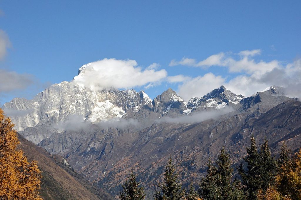 The Four Sister Mountains, an alpine landscape filled with firs and snowy peaks